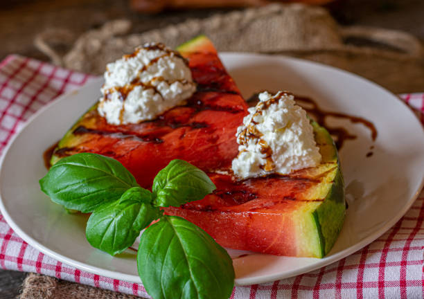 Grilled watermelon with goat cheese and balsamic dressing stock photo