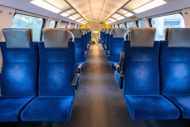 istock Empty blue seats inside train cabin, corridor view, no people. 1338830098
