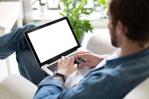 istock Young man working on his laptop with blank copy space screen for your advertising text message in home office 1338832450