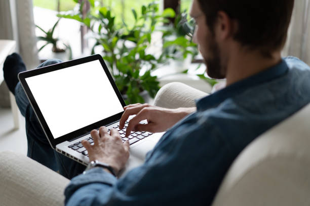 istock Young man working on his laptop with blank copy space screen for your advertising text message in home office 1338832453