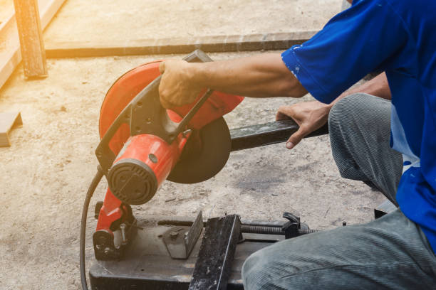istock Worker man cutting steel with a circular steel cutter. 1338832492