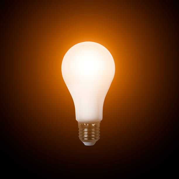 istock Turn on bright LED lamp isolated on black background. LED bulb close up. Idea concept 1338832578