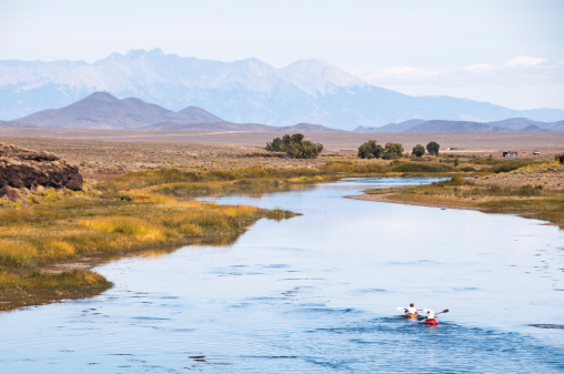A couple sea kayak down the Rio Grande River in Colorado