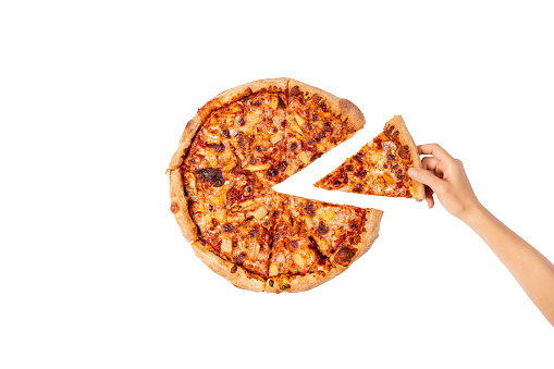 Hand taking a slice of pizza. Big Hawaii pizza without one piece. Top view on Hawaii pizza. Concept for italian food, street food, fast food, quick bite