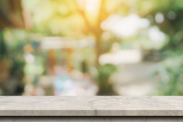 istock Abstract blurred light in coffee shop and cafe bokeh background. Empty concrete table for product display montage template. 1338838214