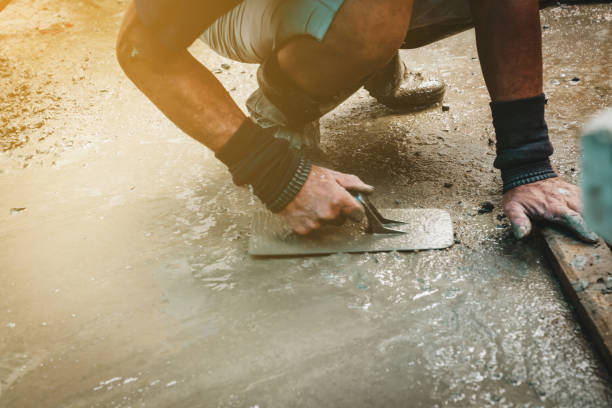 istock Mason building a screed coat cement at home 1338838243