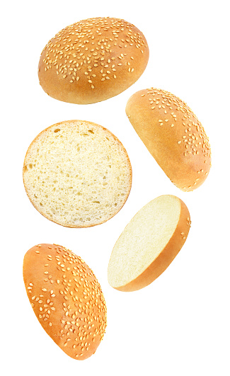 Sesame buns whole and cut set,  falling, hanging, flying, soaring, isolated on white background