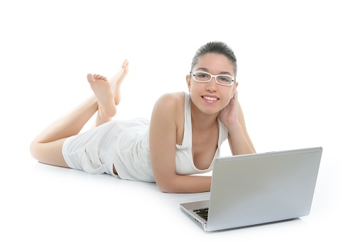 Beautiful woman working laptop on the white floor at studio
