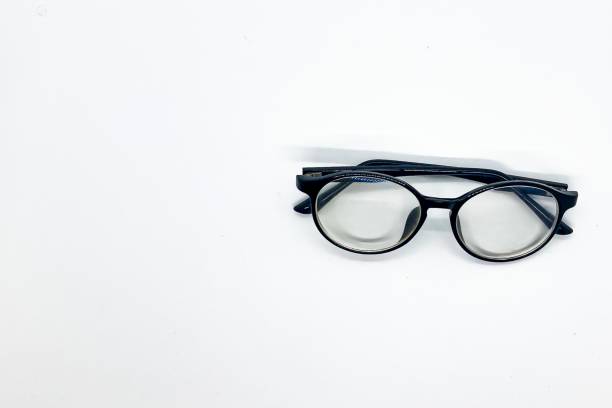 istock Black framed round eyeglasses placed on a white screen. 1338840951