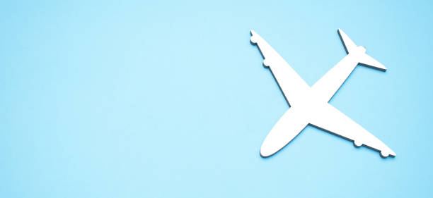 istock model of passenger plane on blue background 1338842863