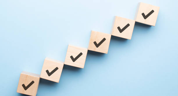istock Wood cube with check mark on blue background, Checklist concept, Copy space. 1338842868