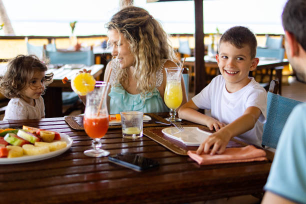 istock Happy family talking while having lunch at restaurant's terrace. 1338845733