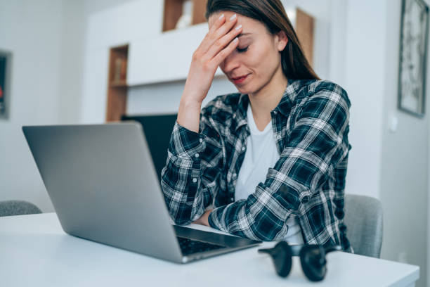 istock Stressed woman using laptop at home. 1338846029