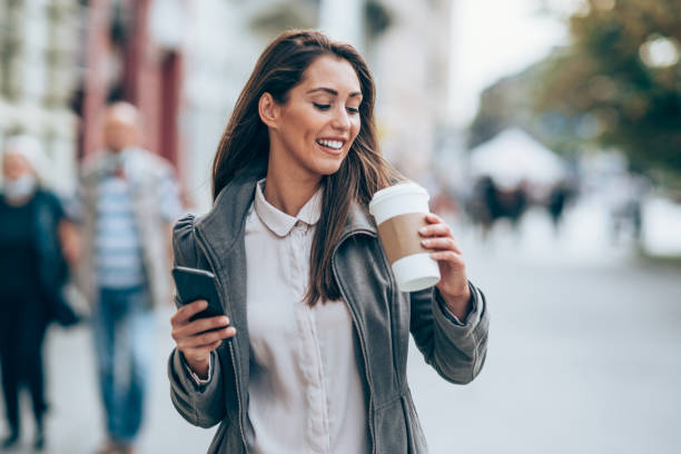 istock Young woman using smartphone on the street. 1338846033