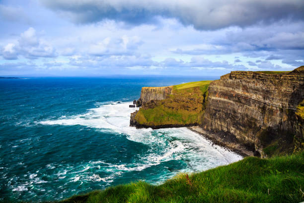 Cliffs of Moher, Ireland Cliffs of Moher, Burren, County Clare, Ireland. Sea cliffs rise above Atlantic Ocean. View from top cliffs in Galway Bay. Popular tourist attraction. Scenic seascape. Irish rural countryside nature. doolin photos stock pictures, royalty-free photos & images