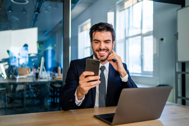 istock Businessman texting on cellphone in the office. 1338846957