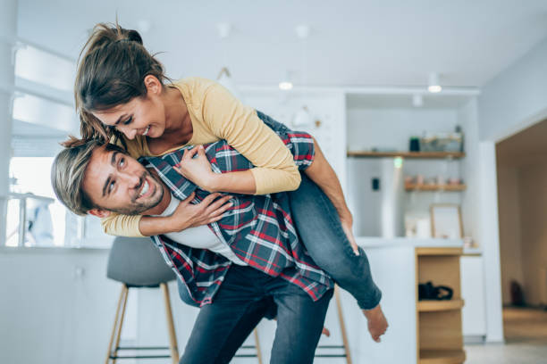 istock Young happy couple piggybacking at home. 1338846967