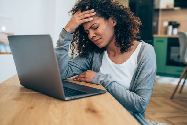 istock Stressed woman using laptop at home. 1338846980