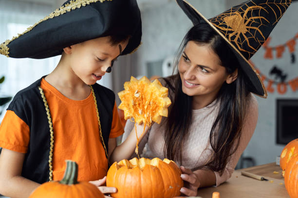 istock Mom with son making pumpkins for Halloween 1338847187