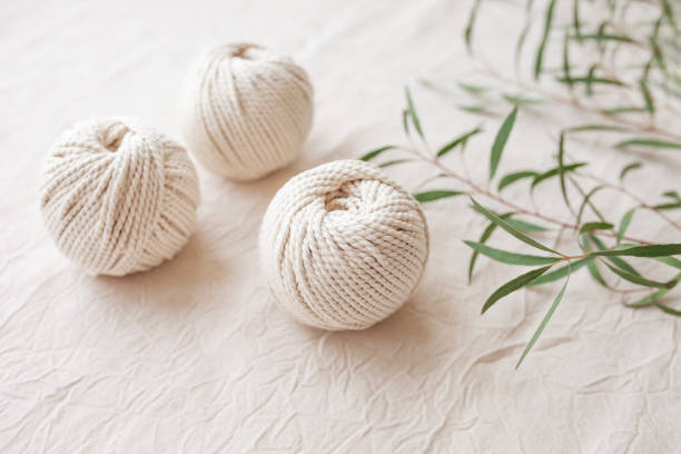 Handmade macrame braiding and cotton threads. Image good for macrame and handicrafts banners and advertisement.  Top view. Copy space