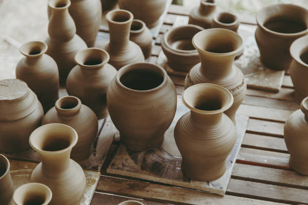 Leather hard handcraft clay pots waiting for dry and bisque fire in pottery process.