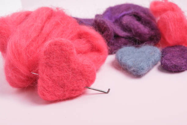 several multi-colored felted woolen hearts, romantic DIY decor, copy space close up