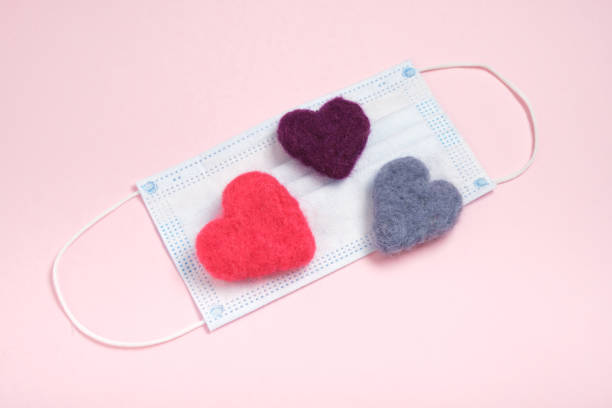 istock face mask and woolen felted hearts on pink background 1338850061
