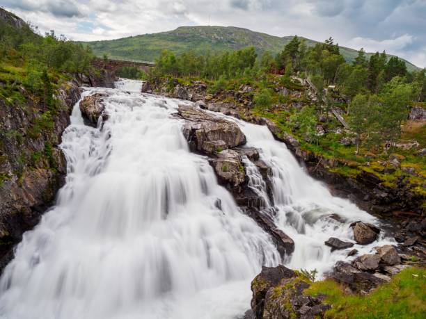 Mountain lake Flotvatnet with waterfall. Scenic region between Aurland and Laerdal in Norway. National tourist route Aurlandsfjellet.