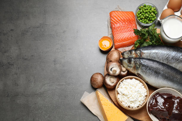 istock Fresh products rich in vitamin D on grey table, above view. Space for text 1338852071