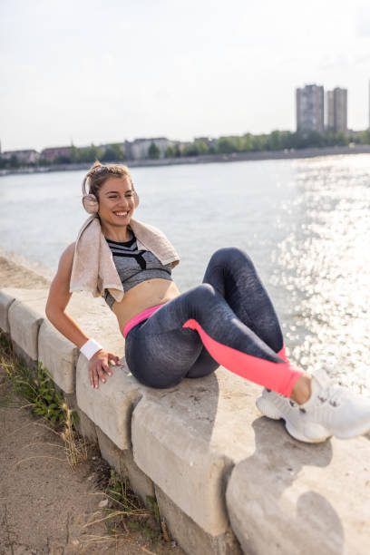 istock Athlete woman doing warm up exercise by the river 1338852297