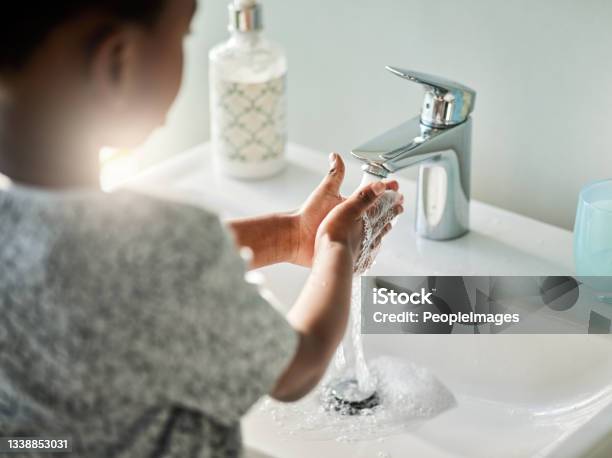 Closeup Shot Of An Unrecognisable Boy Washing His Hands At A Tap In A Bathroom At Home Stock Photo - Download Image Now