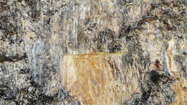 Aerial view of textured rock wall with different colors tunes