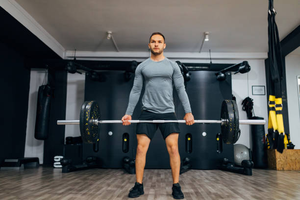 istock Strong man doing the weightlifting training in the modern gym 1338854704