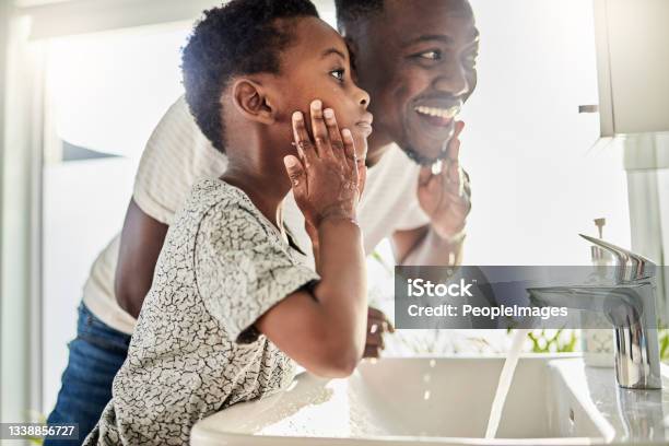 Shot Of A Father And His Son Washing Their Faces Together In A Bathroom At Home Stock Photo - Download Image Now