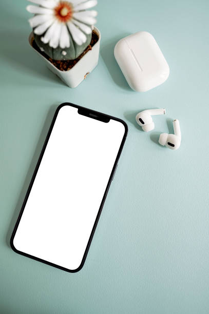istock Flat lay of blank screen smartphone and earphone on light blue backgrond. 1338856891