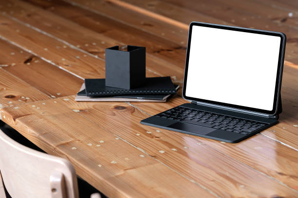 istock Blank screen tablet with keyboard on wooden table. 1338857248