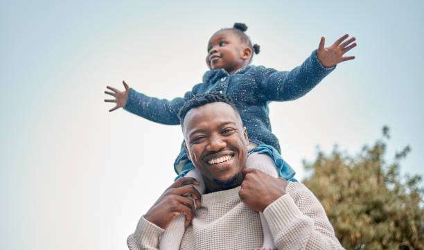 Portrait of a father carrying his daughter on his shoulders outdoors She's always going to be my little princess on shoulders stock pictures, royalty-free photos & images