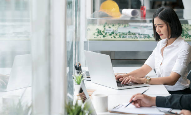 istock Young female engineer working  on laptop in modern office. 1338858285
