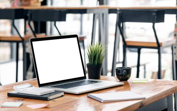 istock Mockup creative workspace with blank screen laptop on wooden table in co-workspace. 1338858362