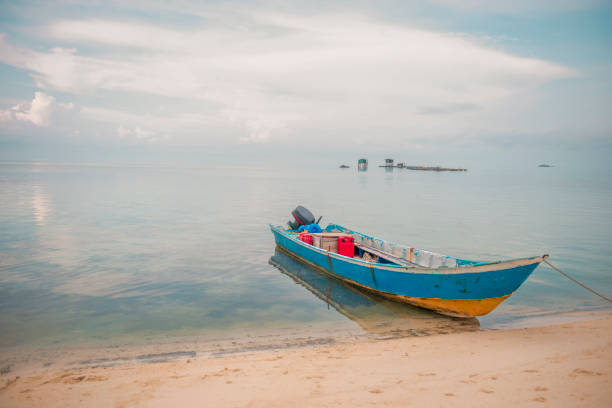 A boat is leaning on one of beautiful beach on Belitung Island