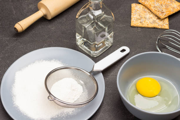 istock Flour and sieve on gray plate. 1338858808