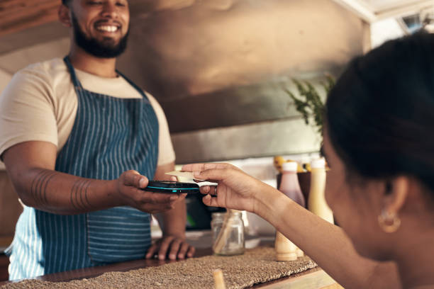 istock Shot of a customer paying for their smoothie 1338858995