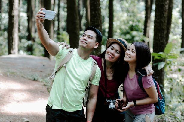 istock Three asian friends taking smartphone selfie 1338859069