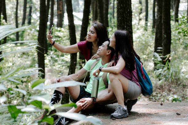 istock Three asian friends taking smartphone selfie 1338859245