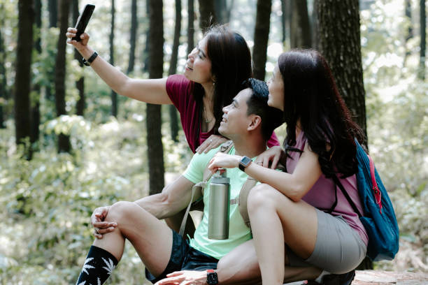 istock Three asian friends taking smartphone selfie 1338859772