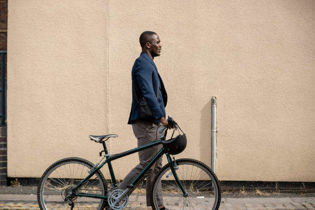 istock Commuter Walking Through the City With His Bicycle 1338862028