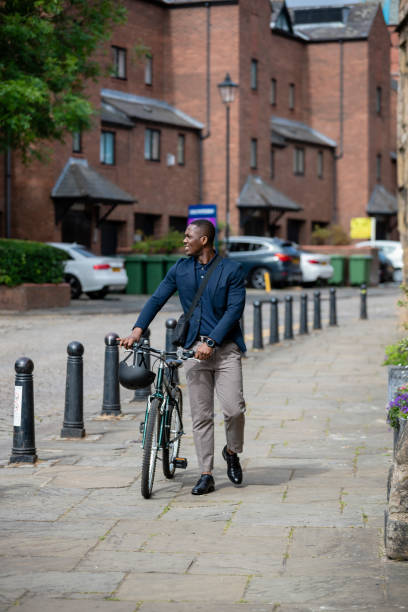 istock Commuter Walking With His Bike 1338862058