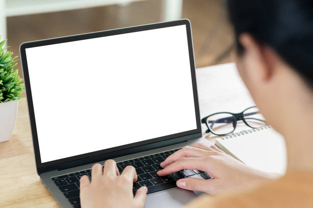 istock Young Asian Woman typing laptop computer keyboard with white blank screen on the table. working at home, relaxing, online shopping, communication and technology concept 1338864388