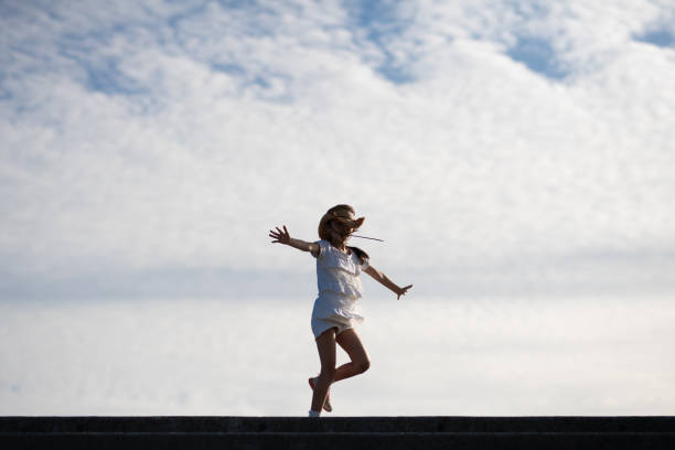 istock Girl playing under the blue sky 1338867154
