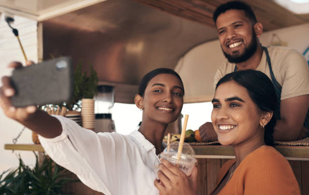 istock Shot of two friends taking selfies while drinking smoothies 1338868404